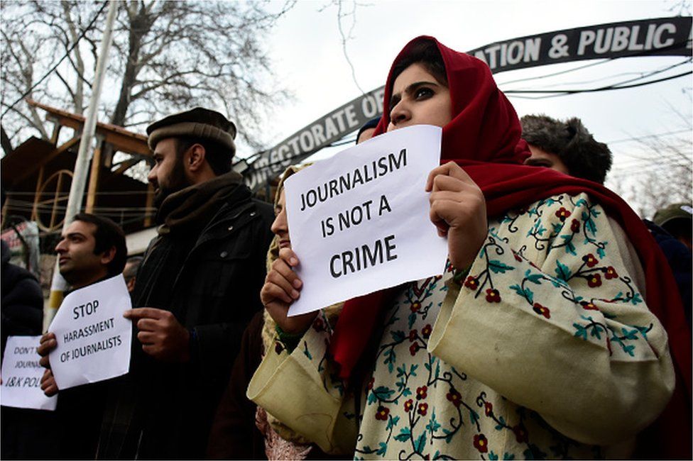 Kashmiri journalists hold placards during a protest against the high handedness of Indian forces in Srinagar, Indian Administered Kashmir on 18 December 2019.