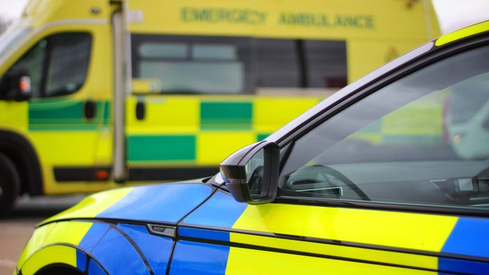 Library image of Cumbria Police car and an ambulance