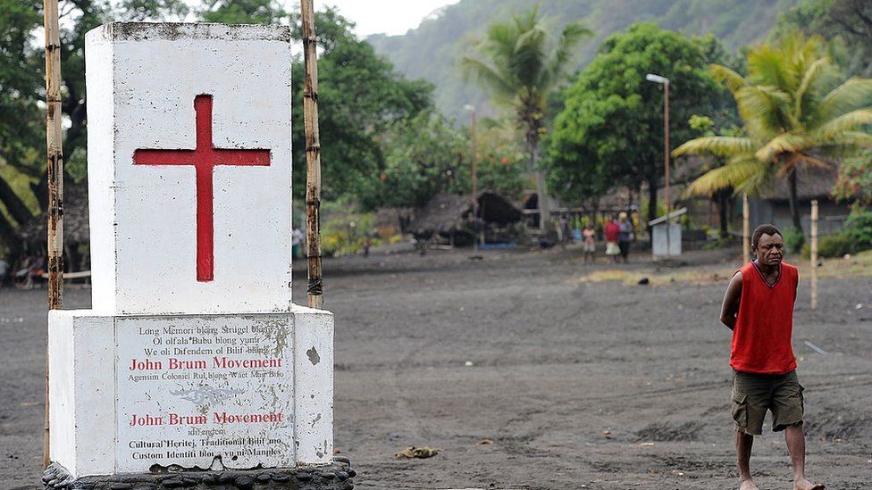 The red cross of the local cargo cult dominates Sulphur Bay's town square below Mount Yasur volcano on Tanna in Vanuatu