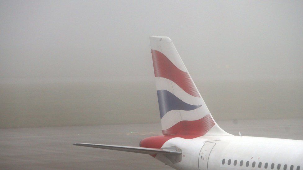A file image of the tailfin of a BA airplane on the runway at Heathrow Airport