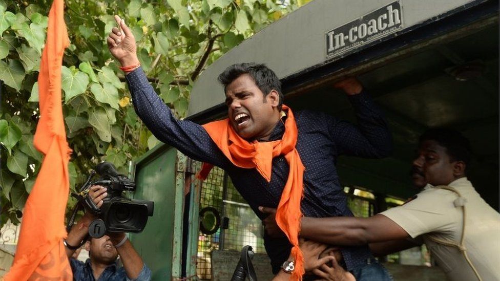 An Indian activist shouts slogans as he is detained by police outside the home of Bollywood actor Aamir Khan in Mumbai on November 24, 2015.
