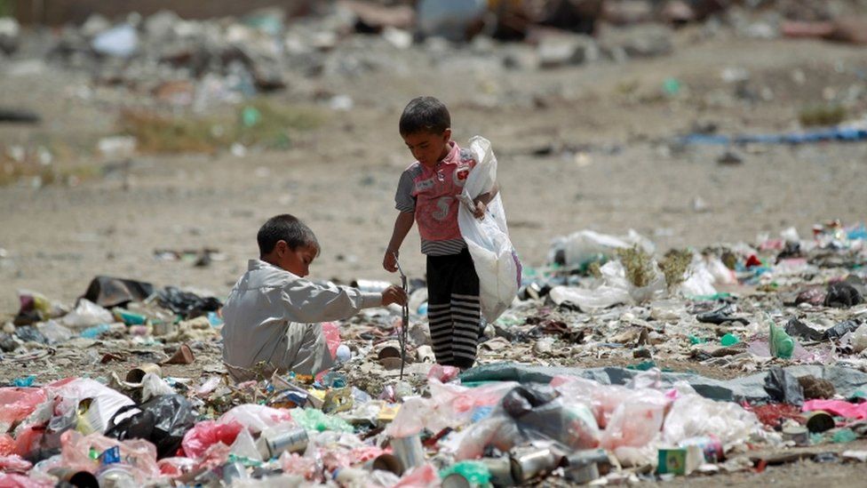 Yemeni children stand amid rubbish at a slum in the capital Sana'a on 12 March 2016