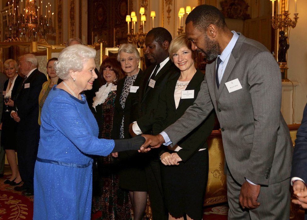 Queen Elizabeth II meets guests, including Lenny Henry, during the Dramatic Arts reception at Buckingham Palace on February 17, 2014 in London