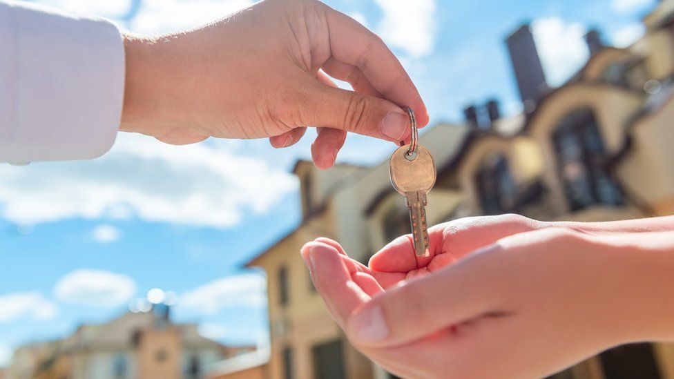 Landlord handing keys to a tenant