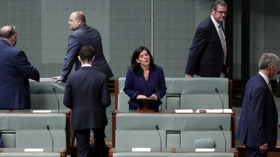 Julia Banks stands to speak in parliament as five male colleagues leave the chamber