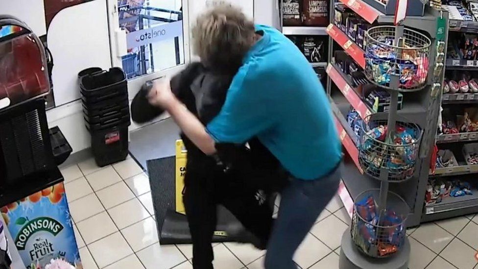 Shop worker confronting robber