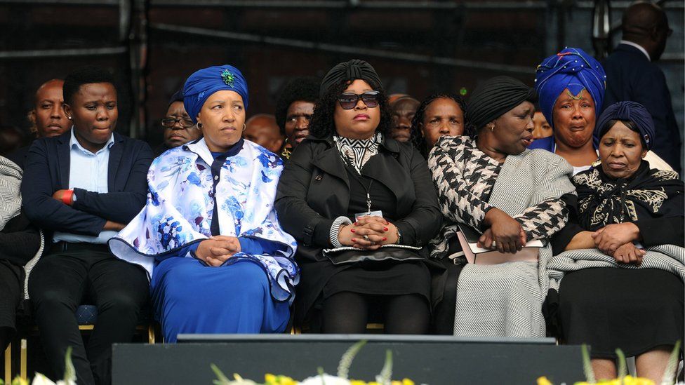 Winnie Madikizela-Mandela's daughters Zanani (2-L) and Zindzi (3-L) with family members attend the memorial service of Winnie Madikizela-Mandela at the Orlando stadium in Soweto, South Africa.