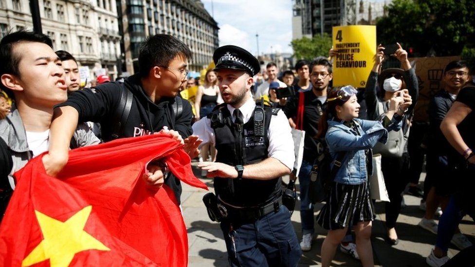 Pro-Beijing demonstrators are separated from supporters of the Hong Kong protestors in London