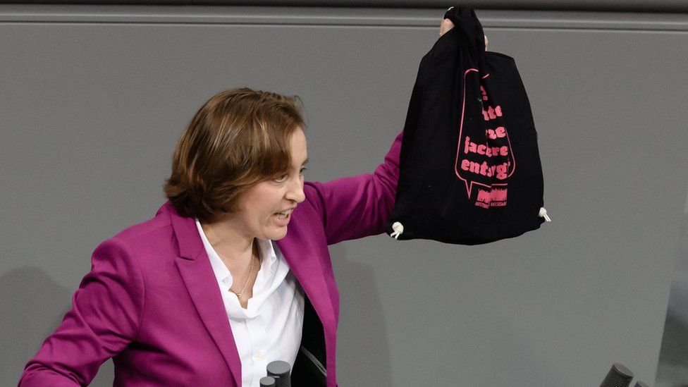 The deputy chair of the parliamentary group of the right-wing Alternative for Germany (AfD) party Beatrix von Storch presents a bag reading "AfD? Appropriate disposal of right-wing agitation!" of the confederation "Standing up against racism" during a session of the German parliament "Bundestag" in Berlin, Germany, 13 December 2017. D