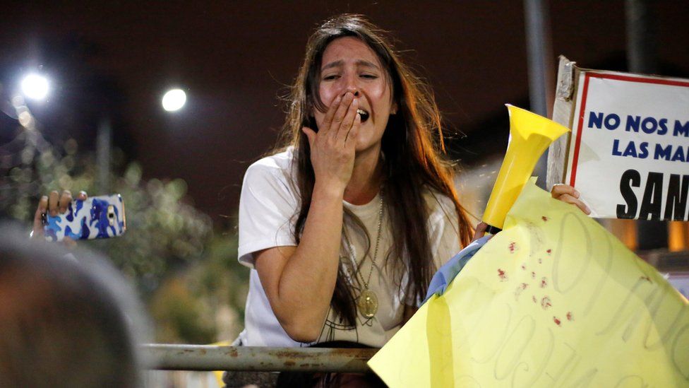 An anti-abortion supporter reacts during a protest outside the National Assembly