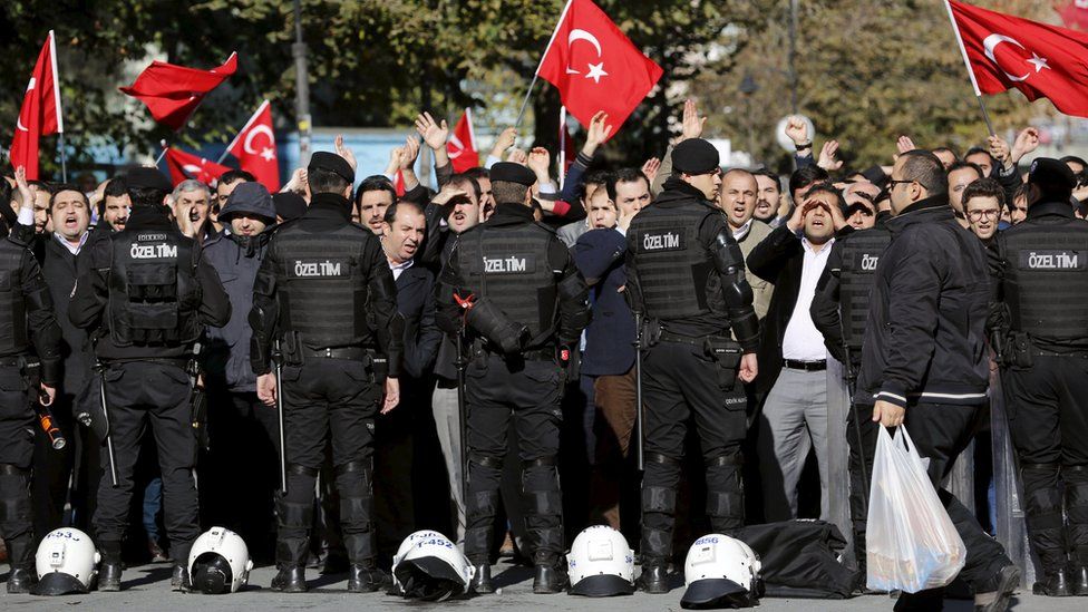 Supporters of Gulen movement shout slogans during a protest outside the Kanalturk and Bugun TV building in Istanbul, Turkey