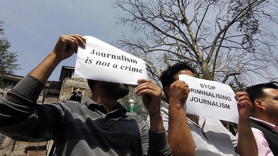 Journalists hold placards as they attend a protest against the communication blockade by Indian government in Srinagar on October 03, 2019