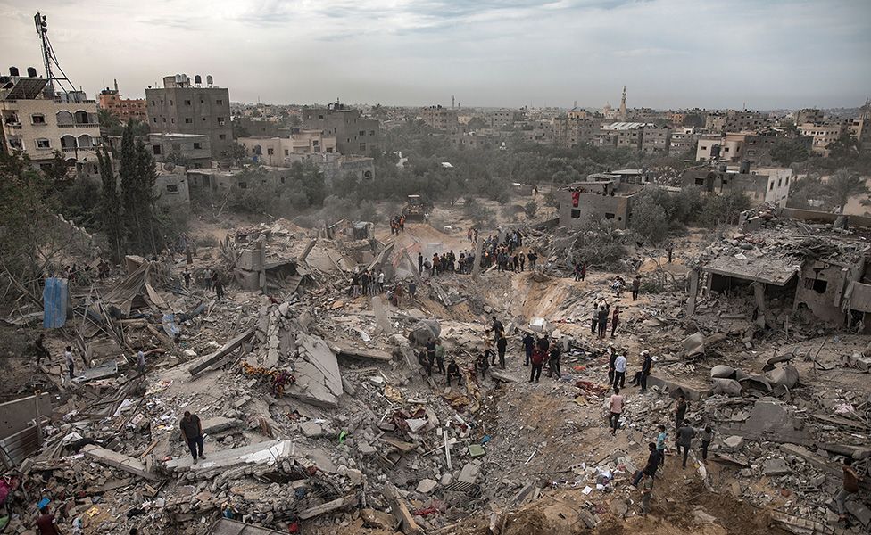 Search for survivors in the rubble of a destroyed building in Khan Younis following an Israeli strike.