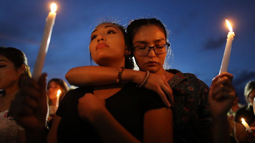 People attend a candlelight vigil at a makeshift memorial for victims of a mass shooting which left at least 22 people dead, on August 7, 2019 in El Paso, Texas