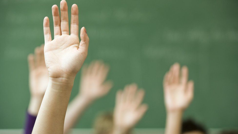 Hands up in a classroom