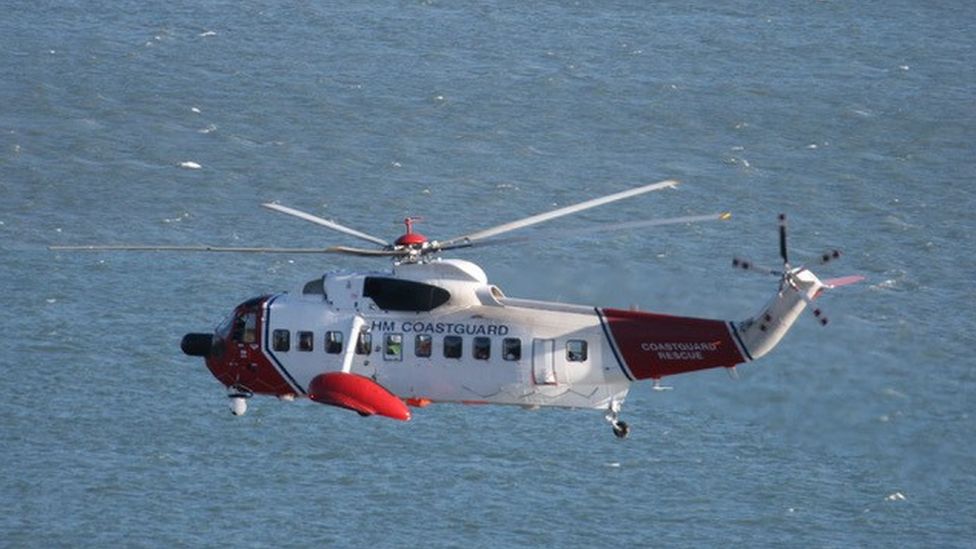 Coastguard helicopter fling over sea
