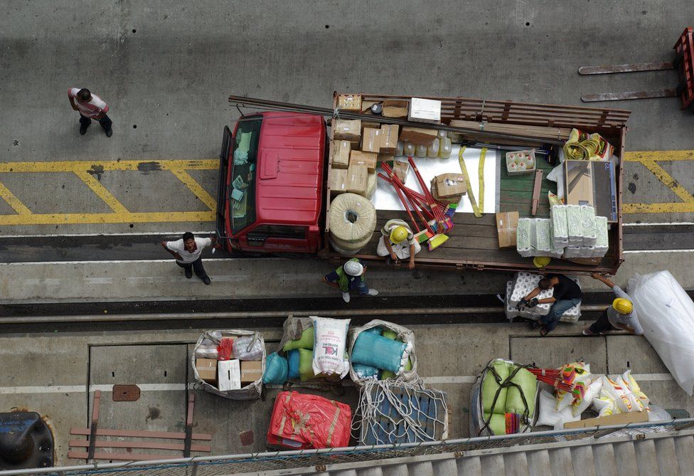 A truck is being loaded with supplies