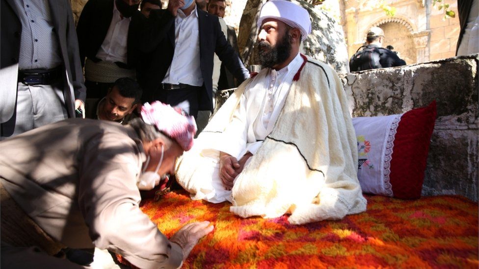 Yazidis pay respects to their new spiritual leader Ali Aliyas at a ceremony in Lalish