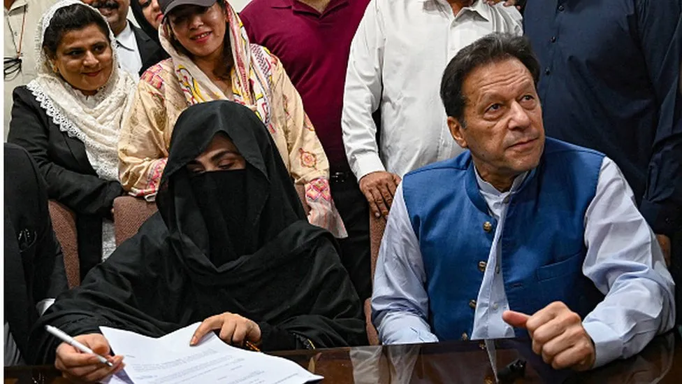 Imran Khan and his wife Bushra Bibi as seen last July in a Lahore court