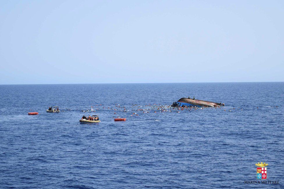 Migrants escape from a capsizing boat in the Mediterranean, 25 May