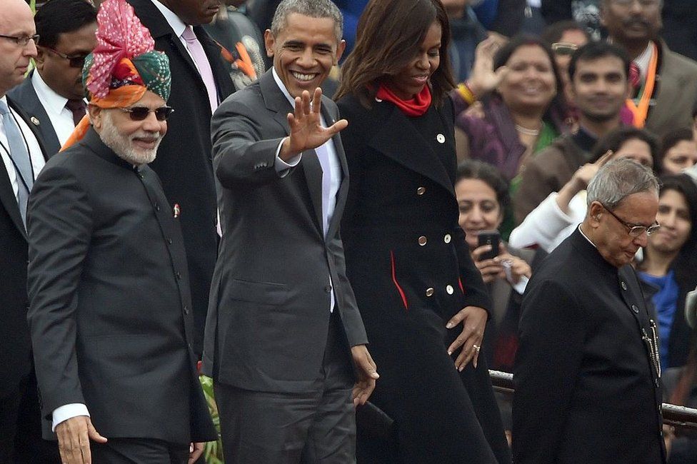 US President Barack Obama (2L) waves to spectators as he leaves with US First Lady Michelle Obama (2R), Indian Prime Minister Narendra Modi (L) and Indian President Pranab Mukherjee (R) after attending India's Republic Day parade on Rajpath in New Delhi on January 26, 2015.