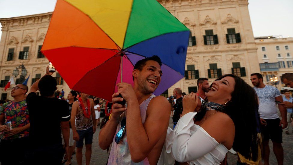 People celebrate after the Maltese parliament voted to legalise same-sex marriage on the Roman Catholic Mediterranean island, in Valletta, Malta