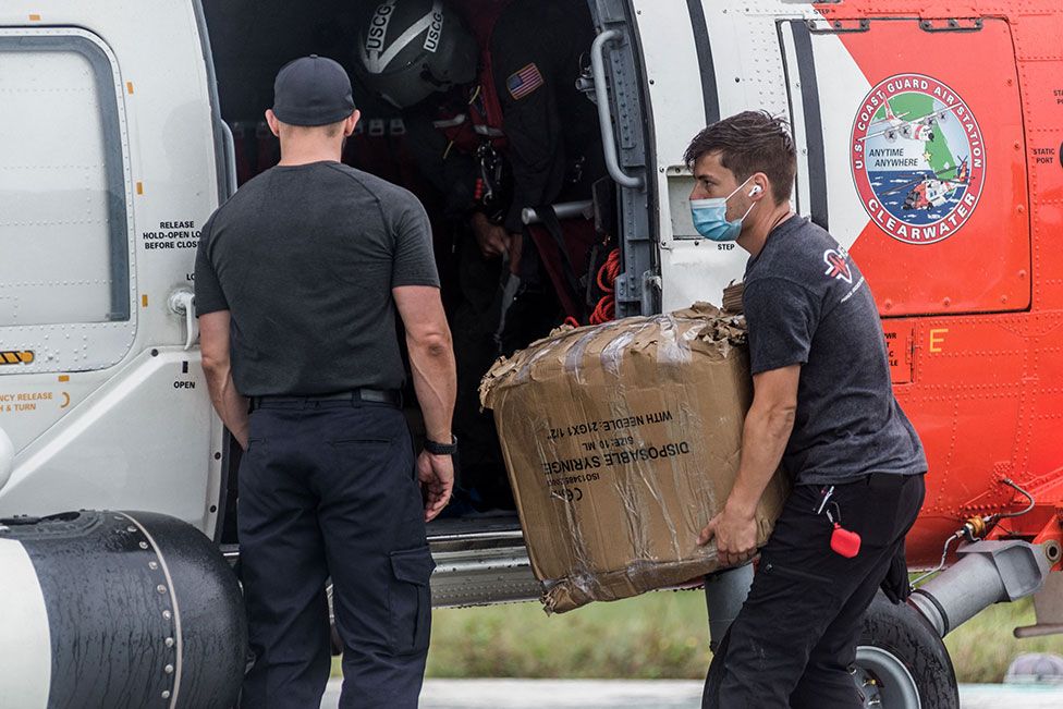 US Coast Guard carry medical supplies to the Ofatma Hospital in Les Cayes, Haiti, on 17 August 2021