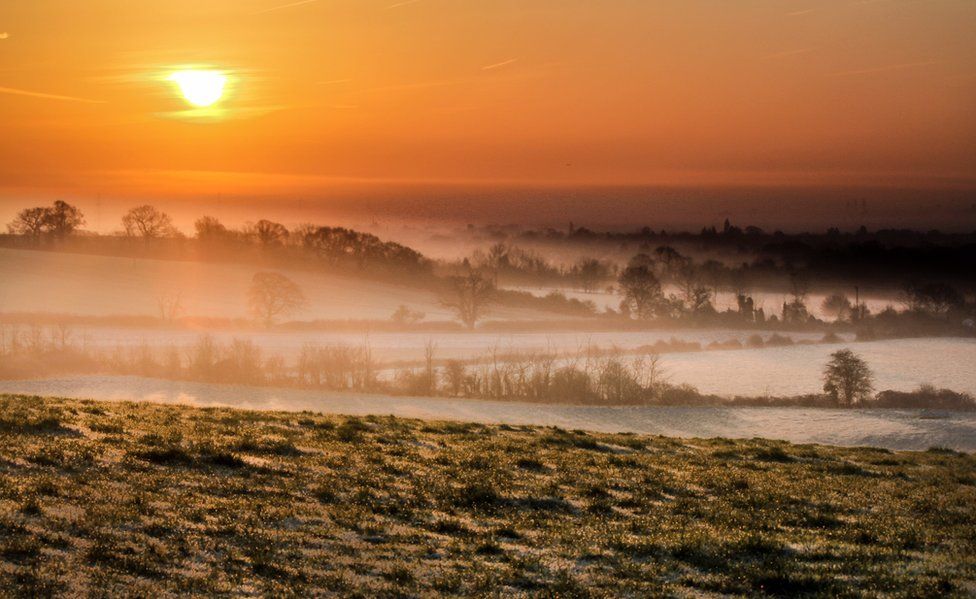 Fields are covered with layers of mist