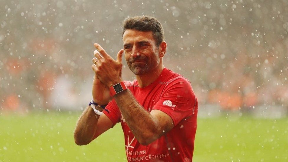 Francis Benali applauded by crowd after run