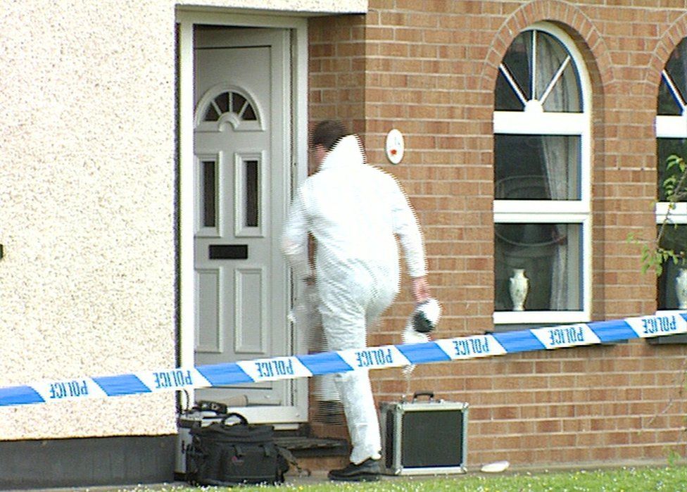 A forensic officer enters the Fulton family home at Old Rectory Heights in Cookstown
