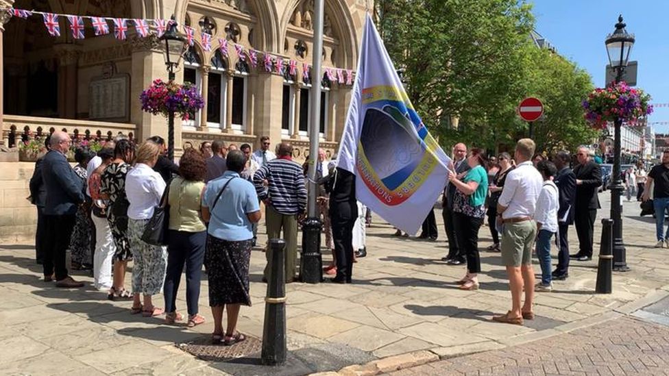Windrush flag being raised in front of Northampton's Guildhall