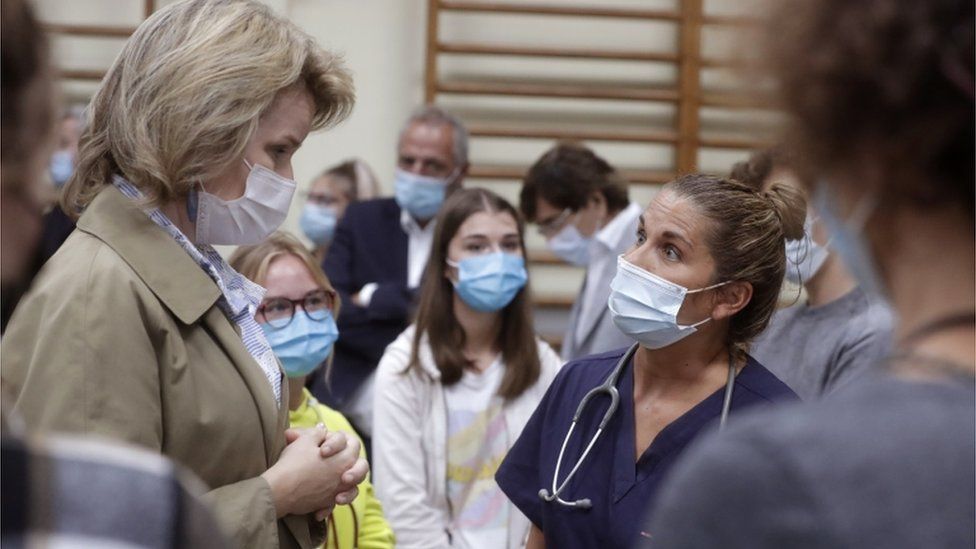 Belgium's Queen Mathilde (left) visits a crisis centre after flooding, July 2021