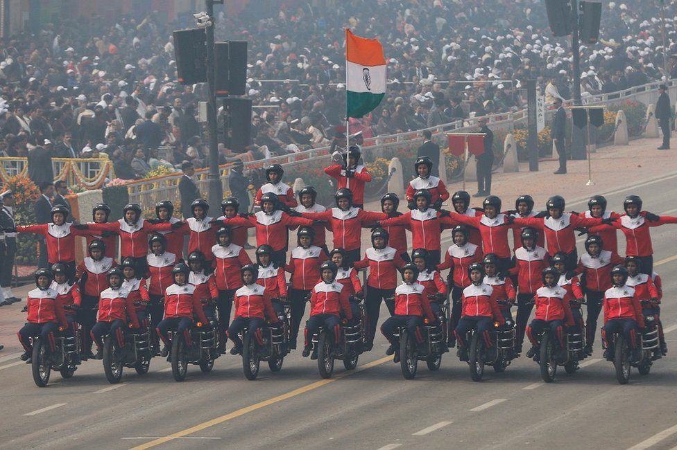Indian women soldiers perform a daredevil on bikes during the Republic Day parade in New Delhi, India, January 2