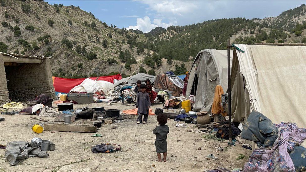 villagers in makeshift tents