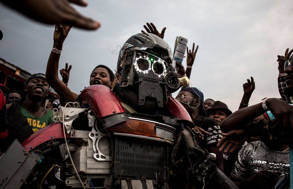 A Congolese festival-goer dressed as a robot.