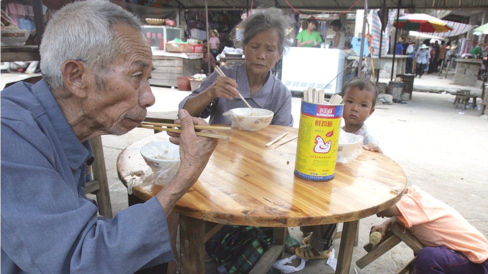 Elderly Chinese people eating a meal