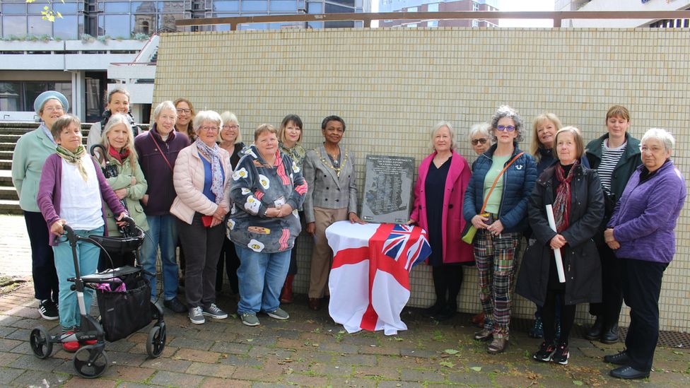 Group unveiling the plaque