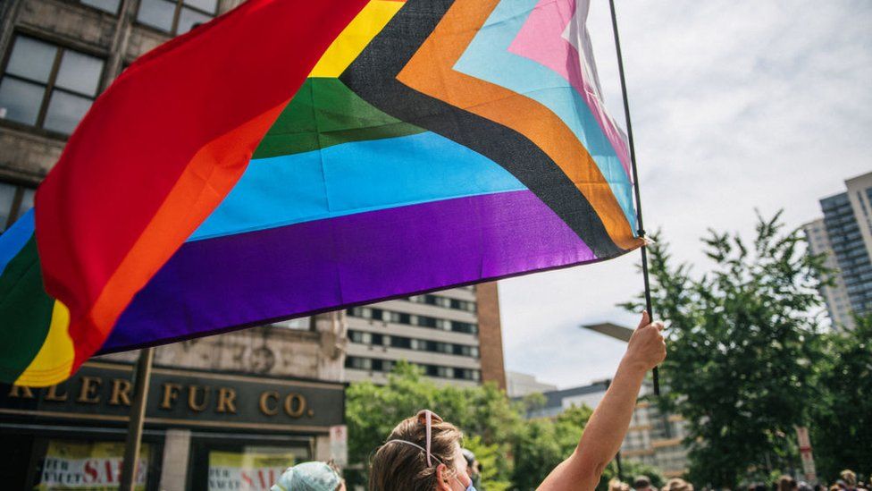 A person waves a flag during a Pride March in Minnesota, 2020