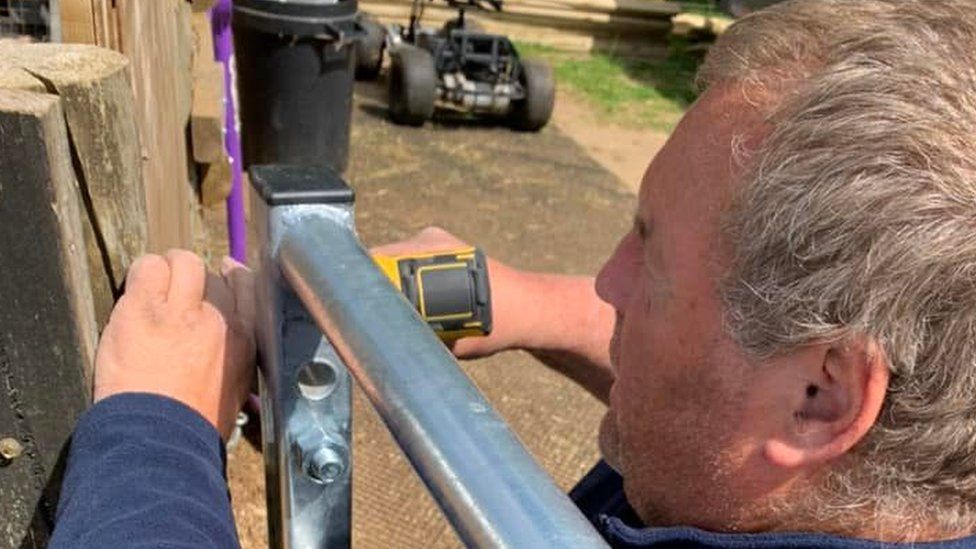 Mike Duxbury using tools on the farm.