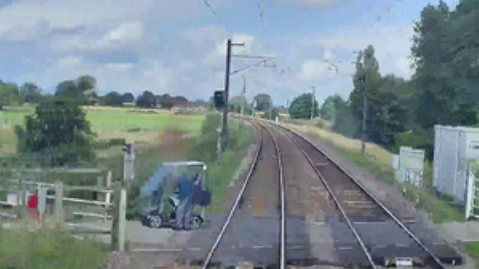 Waterbeach Mobility scooter clipped by train at level crossing BBC News