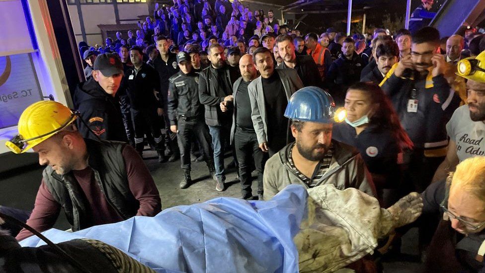 Emergency services rescue people coming out of the mine.