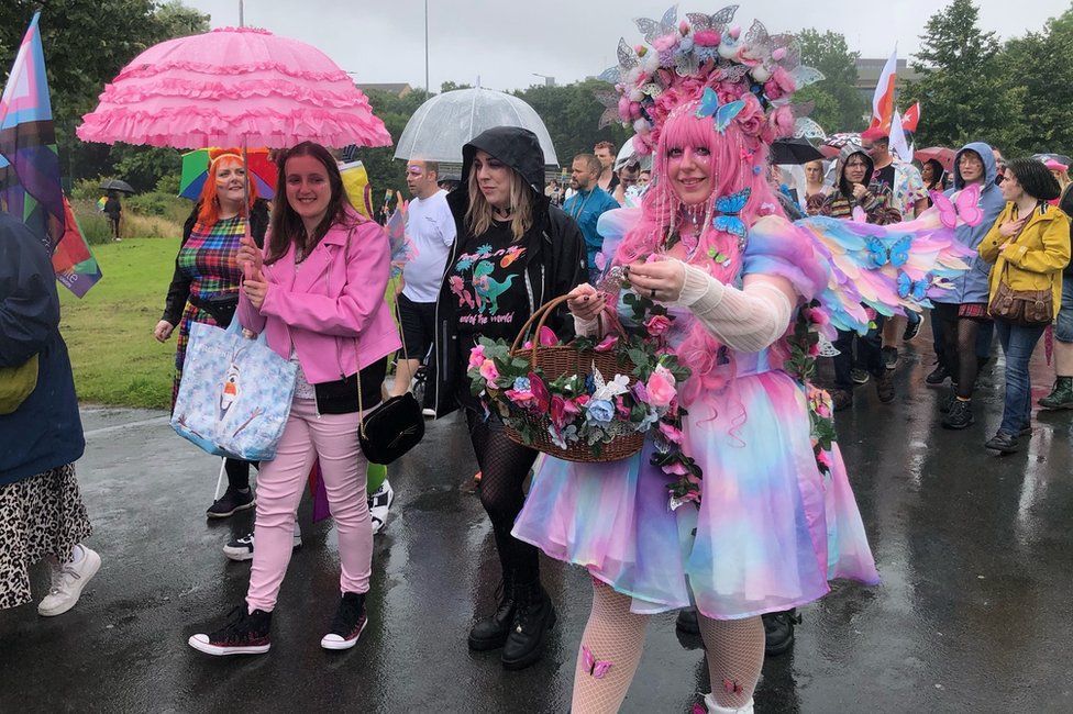 People in pink and blue taking part in the march on Saturday