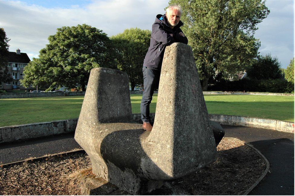 Mark Bonnar in East Kilbride with one of the sculptures he played on as a child