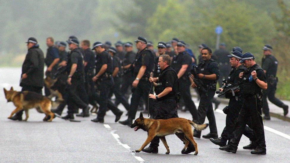 Members of a 450 strong police search team and their dogs begin a search operation in Annersley