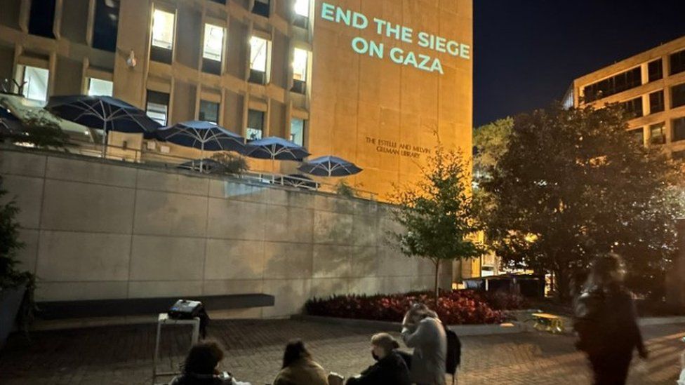 Slogans beamed on to side of library at GW University on 24 October 2023