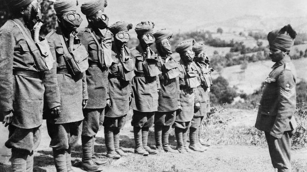 A group of Indian soldiers doing gas mask training