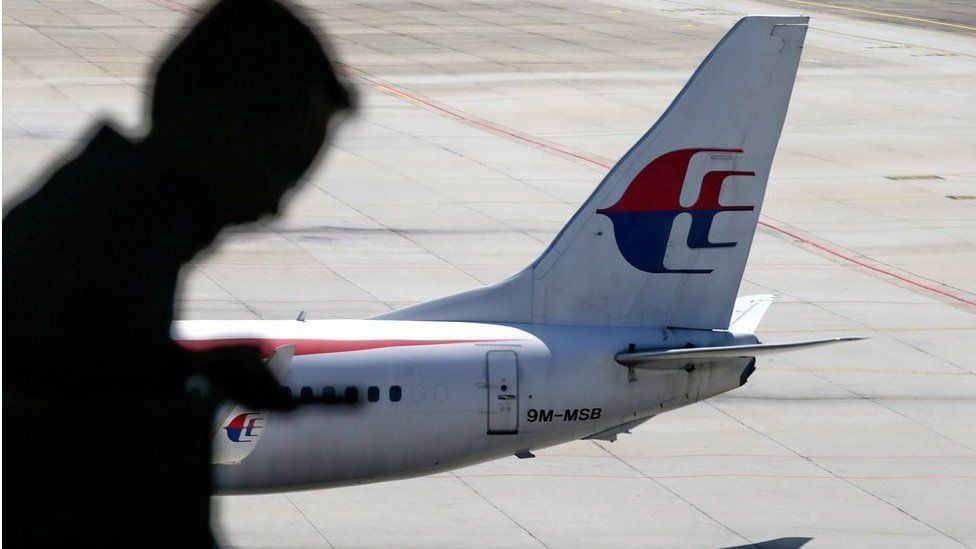 A file picture dated 17 July 2016 shows a passenger walking past a Malaysia Airlines aircraft within a viewing gallery of the Kuala Lumpur International Airport (KLIA) in Sepang, outside Kuala Lumpur, Malaysia.