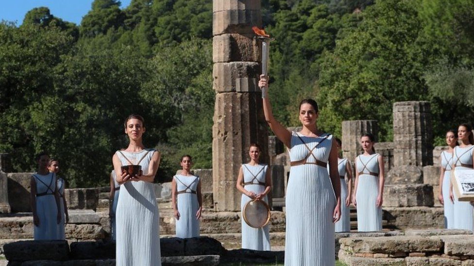 Greek actress Xanthi Georgiou, playing the role of High Priestess, holds the torch and flame during the Olympic flame lighting ceremony for the Beijing 2022 Winter Olympics