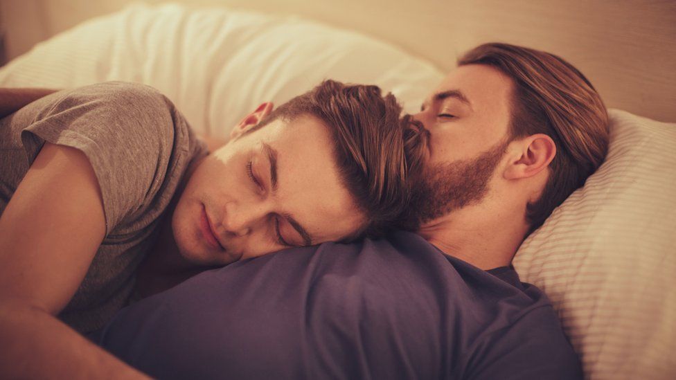 Two men in bed