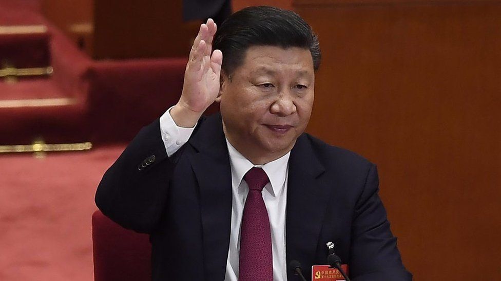 Xi Jinping raises his hand
